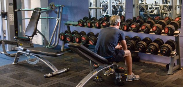 man doing weights in the gym